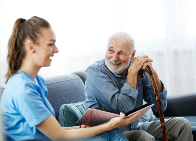 Nurse and older man smiling